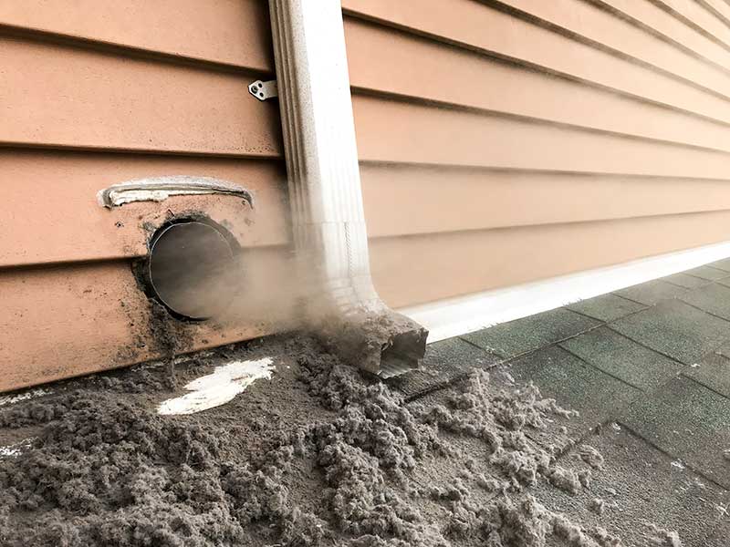 Lint being blown from vent
