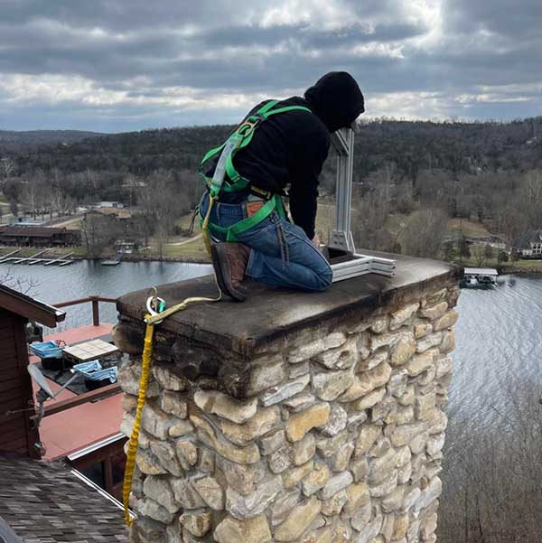 Technician Inspecting Chimney from Outside