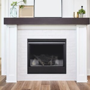 a black gas fireplace insert in a white fireplace facing with decor on the mantel