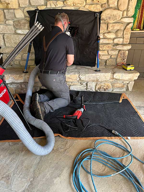 Technician Cleaning Chimney
