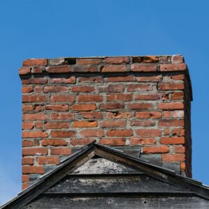 large masonry chimney with some brick damage