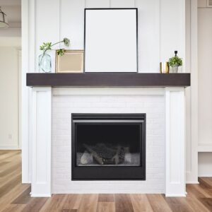 a white fireplace surround with a gas fireplace